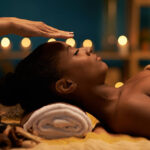 Therapist holding hands above head of the patient to transfer energy