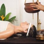Caucasian woman having Ayurveda shirodhara treatment in India